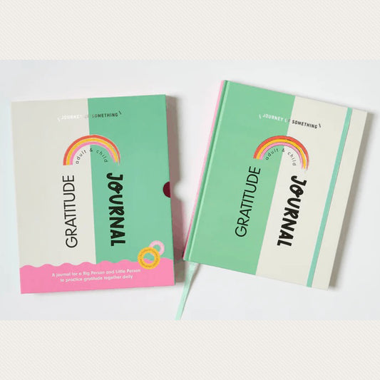 Two journals with green and pink covers, titled 'gratitude' and 'Journey of Something',