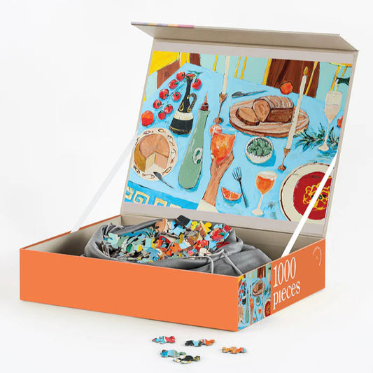 Puzzle with pieces spilling out of an open box featuring a colorful illustration on a white background