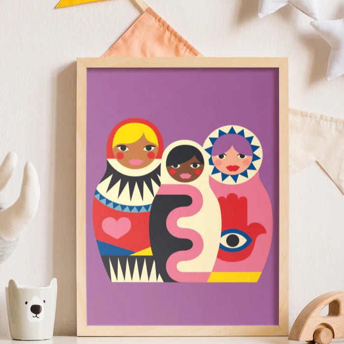 Framed artwork with colorful abstract figures on a purple background, displayed on a shelf.