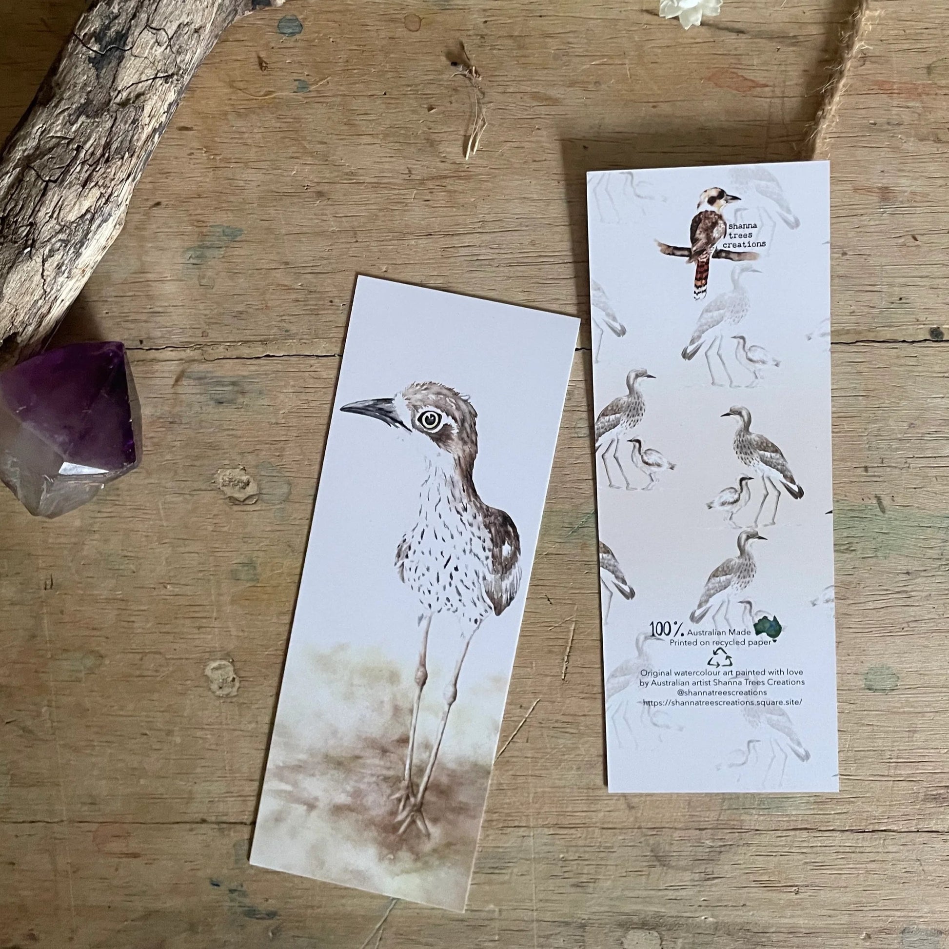 Bird-themed bookmarks on a wooden surface with decorative elements.